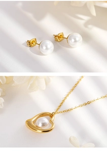 Detail of gold heart pendant and pearl earrings set on white surface with flowers
