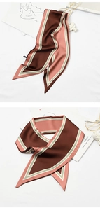 Close-up of brown and pink geometric striped silk scarf as a stylish bag accessory