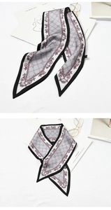 Detailed flat lay of a grey pointed silk scarf with black piping and geometric patterns