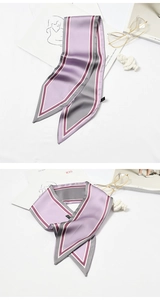 Detail of a diagonal striped silk scarf with purple and grey tones for handbag decoration