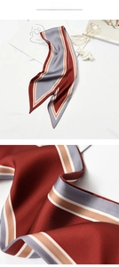 Detailed texture of striped satin scarf with red, grey, and champagne silk fabric shine