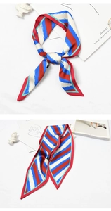 Close-up of red blue and white striped silk scarf tied as a stylish handbag accessory