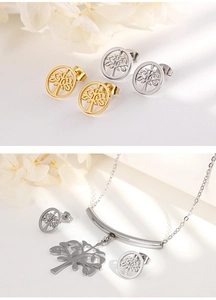 Detail shot of tree of life jewelry set including silver necklace and two-tone stud earrings