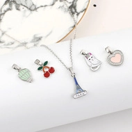 Detailed view of silver necklace with colorful enamel Eiffel Tower and balloon charms