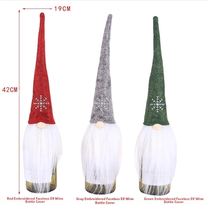Detail view of gnome wine bottle covers with embroidered snowflakes, 42cm height and 19cm width