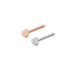 Detailed view of heart-shaped nose studs in rose gold and silver stainless steel