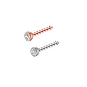 Detail of silver and rose gold stainless steel nose studs with clear zircon crystals