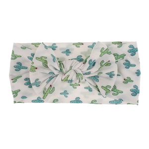Detail view of soft nylon baby headband with cute cactus print and bow knot.