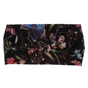 Detail view of floral and butterfly print nylon baby headband with a decorative knot bow.