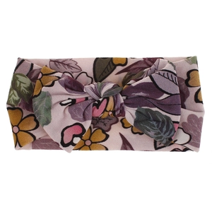 Detailed macro view of baby nylon headband featuring floral print and soft bow knot