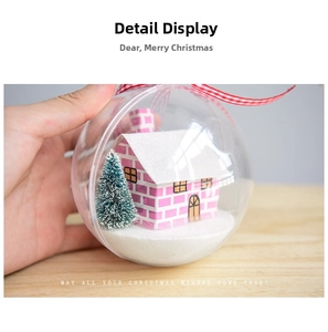 Detailed view of clear Christmas ornament with a mini house and snowy tree inside