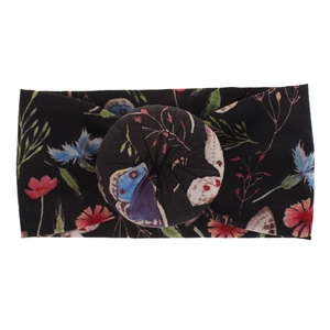 Vista detallada de diadema de nailon floral con suave nudo de donut de estilo bohemio