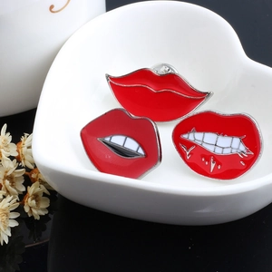 Set of red enamel lip pins in a heart ceramic dish, creative metal brooch collection