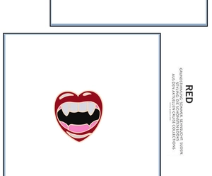 Detail of red vampire lip enamel pin with heart shape and sharp fangs on white background