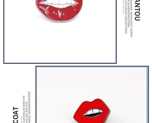 Detail of red lips enamel pins made of zinc alloy with pop art style and shiny finish