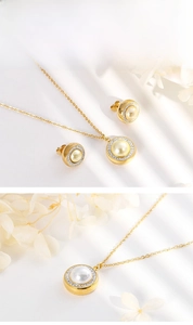 Detail view of a gold jewelry set featuring pearl pendants surrounded by small crystals