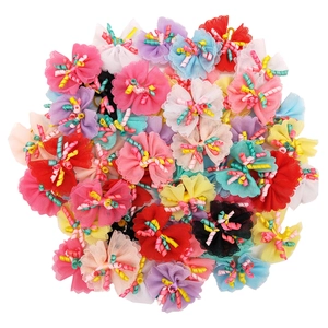 Detail of colorful lace pet hair bows with curly ribbon mesh for dogs and cats