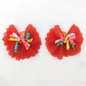 Detail of red lace pet hair bows with colorful curly ribbons and elastic bands