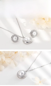 Detailed view of stainless steel jewelry set featuring pearl pendants with crystals