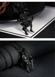 Macro detail of a unique stainless steel skeleton pendant sitting on a toilet on black chain