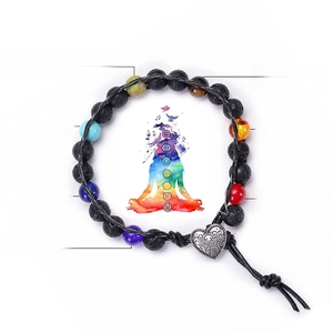 Detail of seven chakra energy stones including tiger eye and amethyst on a lava rock bracelet