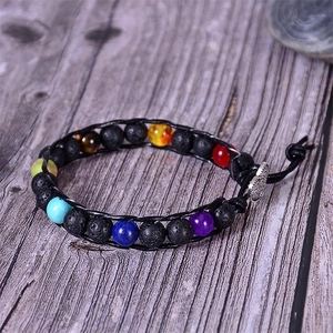 Detail of seven chakra beads and lava stone woven in black leather with heart clasp