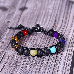 Close-up of lava rock and colorful stone beads on a multi-layer woven leather bracelet