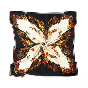 Detailed close-up of butterfly and flower print on silk satin large square scarf wrap