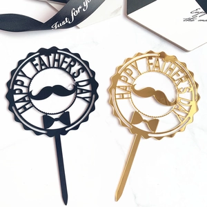 Detail of round acrylic Happy Father's Day cake toppers with mustache and bowtie design