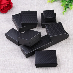 Black diamond texture jewelry gift boxes in various sizes on grey fabric background