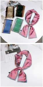 Detail of satin twilly scarves with horsebit chain prints in five elegant colors