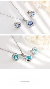 Detailed close-up of blue crystal pendant necklace and matching stud earrings set