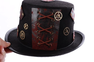 Detail of steampunk top hat with bronze gears, brown leather straps and metal rivets