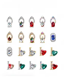Macro display of diverse nail charms including alloy hearts and drop-shaped rhinestones