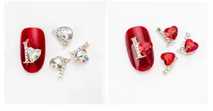 Detail view of heart-shaped alloy nail jewels with AB crystals and red rhinestones