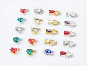 Macro shot of assorted colorful AB nail art crystals with gold and silver alloy bases