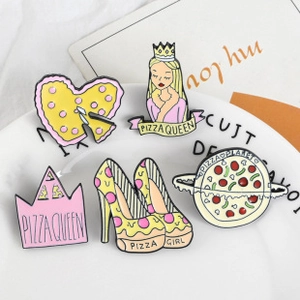 Detailed close-up of pizza planet themed enamel pins set on a white ceramic plate