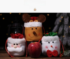 Three burlap Christmas drawstring gift bags featuring Santa, reindeer, and snowman designs