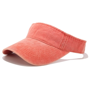 Close-up of coral orange washed cotton sun visor hat showing fabric texture and seams