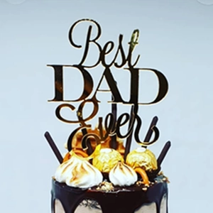 Close-up of golden mirror acrylic Best DAD Ever topper on a chocolate cake