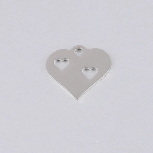 Macro shot of silver hollow double heart pendant made of mirrored stainless steel