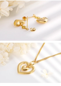Detailed view of golden heart pendant necklace and matching stud earrings jewelry set