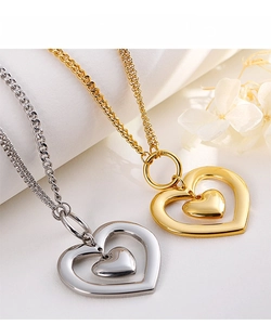 Macro detail of gold and silver heart pendants with hollow and solid layered design