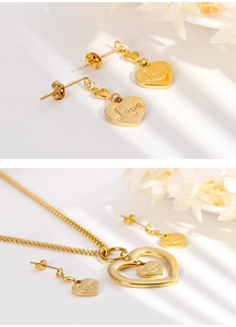 Detail view of a gold double heart jewelry set including earrings and a Love necklace