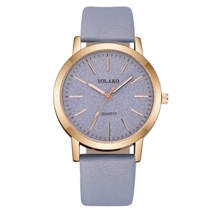 Detailed close-up of a women's watch with purple dial and grey leather strap