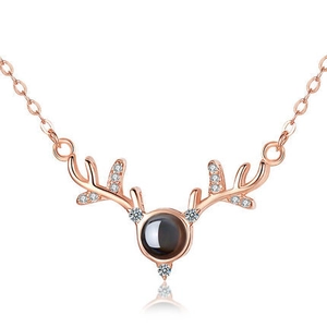 Detail of rose gold deer antler necklace with micro-inlaid stones and black main crystal