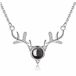 Macro shot of silver deer antler necklace featuring a central black stone and zircon accents