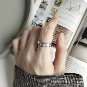 Detail of 925 sterling silver criss-cross ring with sparkling diamond pavé setting