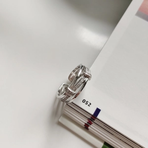 Macro detail of multi-layer 925 sterling silver ring with paved zircon on a book