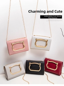 Detail showing various colors of mini crossbody bags with cat-shaped metal hardware and chains